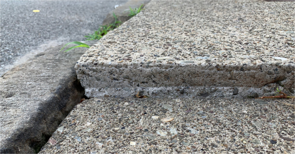 Photo of uneven sidewalk that could cause a slip & fall